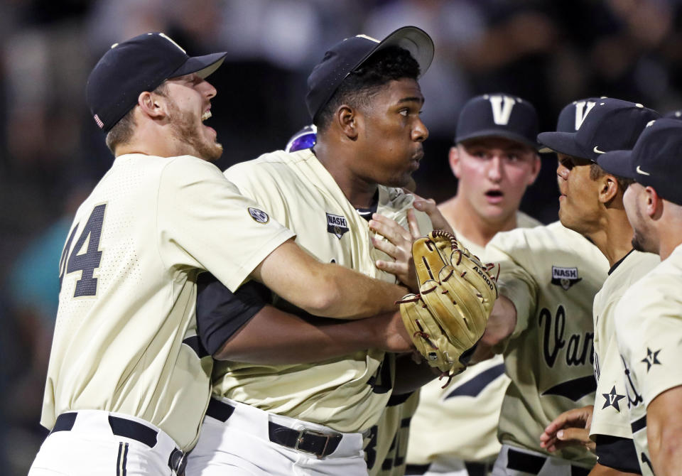 Vanderbilt's Kumar Rocker (80) is congratulated by teammates after he threw a no-hitter against Duke in an NCAA college baseball tournament super regional game Saturday, June 8, 2019, in Nashville, Tenn. Vanderbilt won 3-0. (AP Photo/Wade Payne)