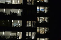 Workers continue working into the night in the City of London, Britain on October 16, 2017. Picture has been rotated 180 degrees. Picture taken October 16, 2017. REUTERS/Mary Turner