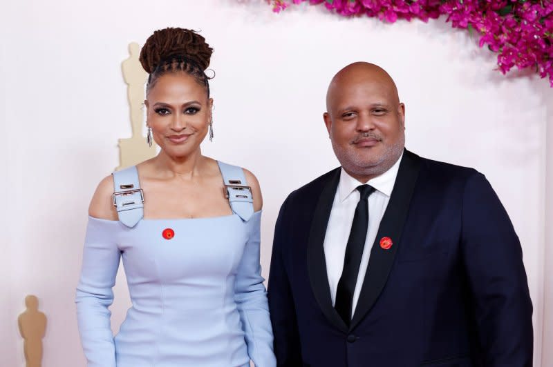 Ava DuVernay and Paul Garnes wore red pins to the Oscars on Sunday. Photo by John Angelillo/UPI