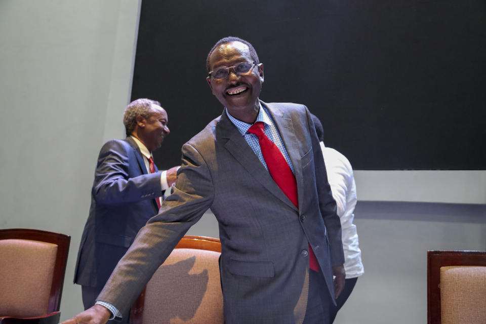 Chief of Staff of Ethiopian Armed Forces Field Marshall Birhanu Jula, center, smiles after being congratulated by Kenya's former President Uhuru Kenyatta, who then congratulated Head of the Tigray Forces Lieutenant General Tadesse Werede, behind left, at Ethiopian peace talks in Nairobi, Kenya Saturday, Nov. 12, 2022. Top military commanders from Ethiopia and its embattled Tigray region agreed Saturday to allow unhindered humanitarian access to the region and form a joint disarmament committee following last week's truce. (AP Photo/Brian Inganga)