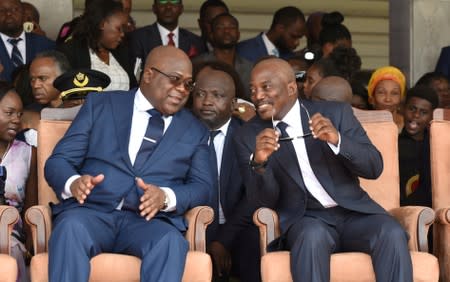 FILE PHOTO: Democratic Republic of Congo's outgoing President Joseph Kabila sits next to his successor Felix Tshisekedi during an inauguration ceremony in Kinshasa