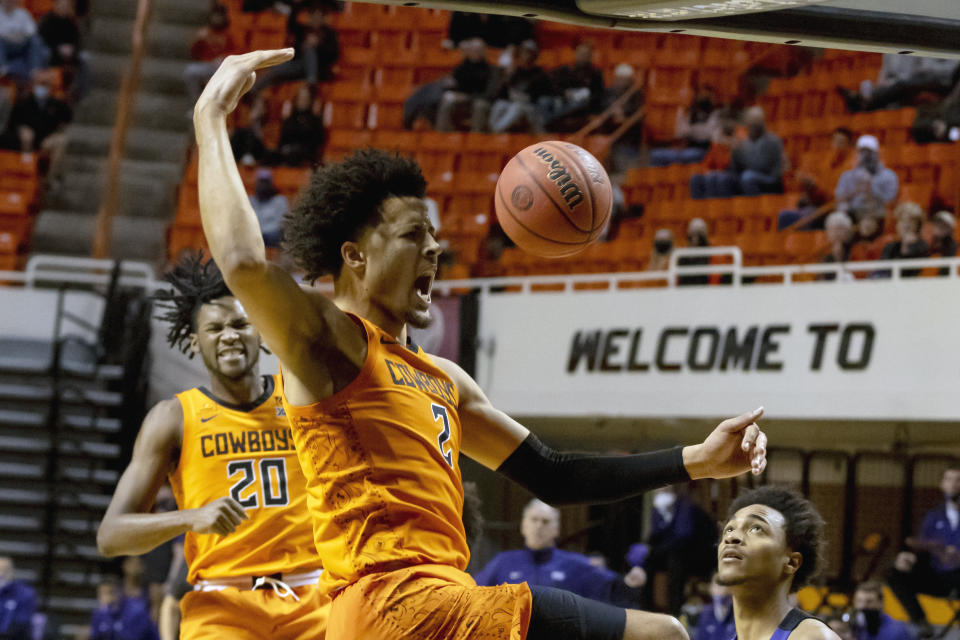 FILE - Oklahoma State guard Cade Cunningham (2) celebrates with Keylan Boone (20) after slam dunking the ball during the second half of the NCAA college basketball game against Texas Christian in Stillwater, Okla., in this Wednesday, Dec. 16, 2020, file photo. Cunningham has made The Associated Press All-America first team, announced Tuesday, March 16, 2021.(AP Photo/Mitch Alcala, File)