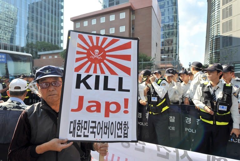 A protester holds a placard during an anti-Japanese rally over South Korean comfort women, outside the Japanese embassy in Seoul, on September 24, 2012. Up to 200,000 women from Korea, China, the Philippines and elsewhere were forcibly drafted into brothels catering to the Japanese military in territories occupied by Japan during WWII, according to many mainstream historians