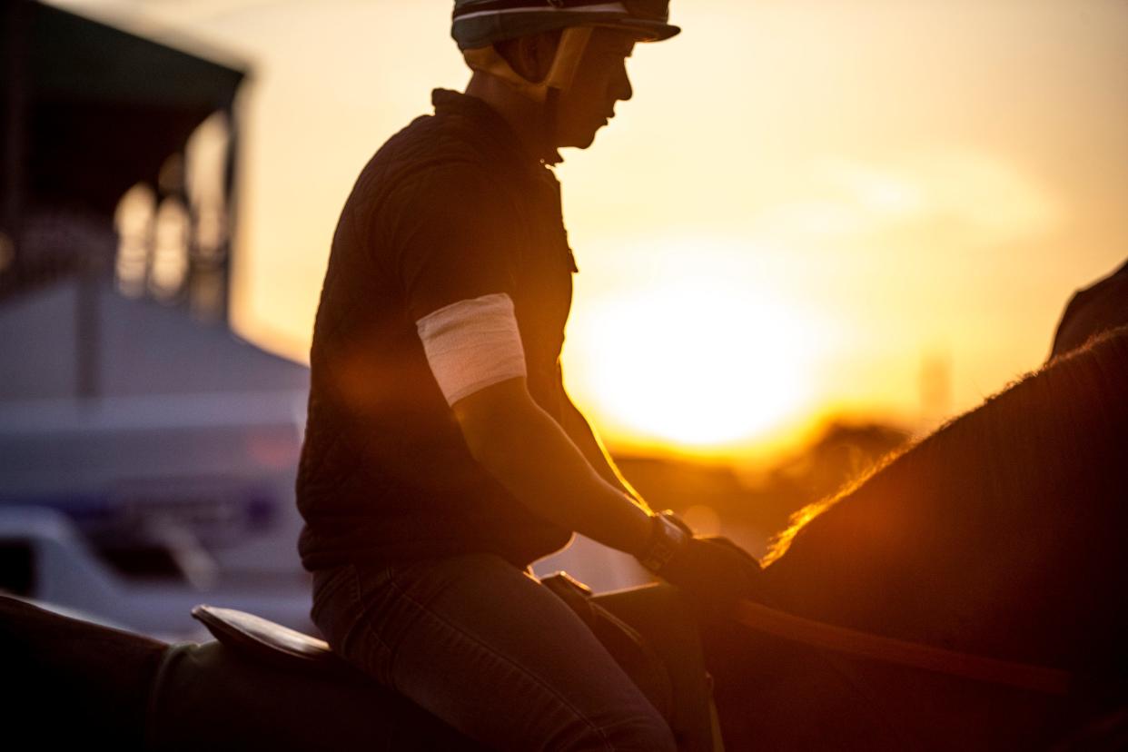 An exercise rider at Churchill Downs wore a white arm band during morning workouts in honor of the late Callie Witt, a rider who died recently at Keeneland. May 5, 2022