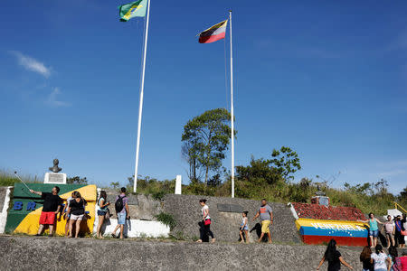 FILE PHOTO: People stand at the border with Venezuela, seen from the Brazilian city of Pacaraima, Roraima state, Brazil November 16, 2017. Picture taken November 16, 2017. REUTERS/Nacho Doce