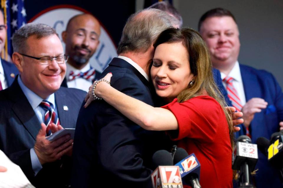 N.C. Rep. Tricia Cotham gets a hug from N.C. Senate leader Phil Berger as House Speaker Tim Moore, left, looks on during a press conference April 5, 2023, to announce that Cotham was switching parties to become a member of the House Republican caucus.