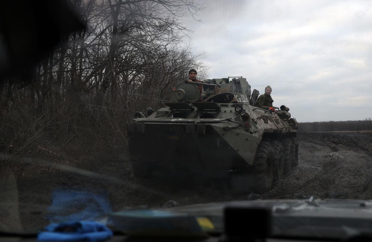A Ukrainian armoured personnel carrier (APC) rides by a road outside Bakhmut, in the Donetsk region on 3 March 2023 (AFP via Getty Images)