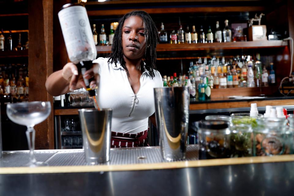 Loretha Kirk mixes a drink on Feb. 20 inside the T Room at The Jones Assembly.