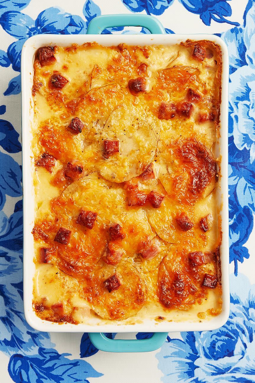 scalloped potatoes and ham casserole on blue floral linen