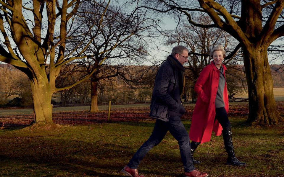 Mrs May, wearing an Egg coat and a Sine for Egg sweater, with her husband Philip - Credit: Annie Leibovitz/Vogue