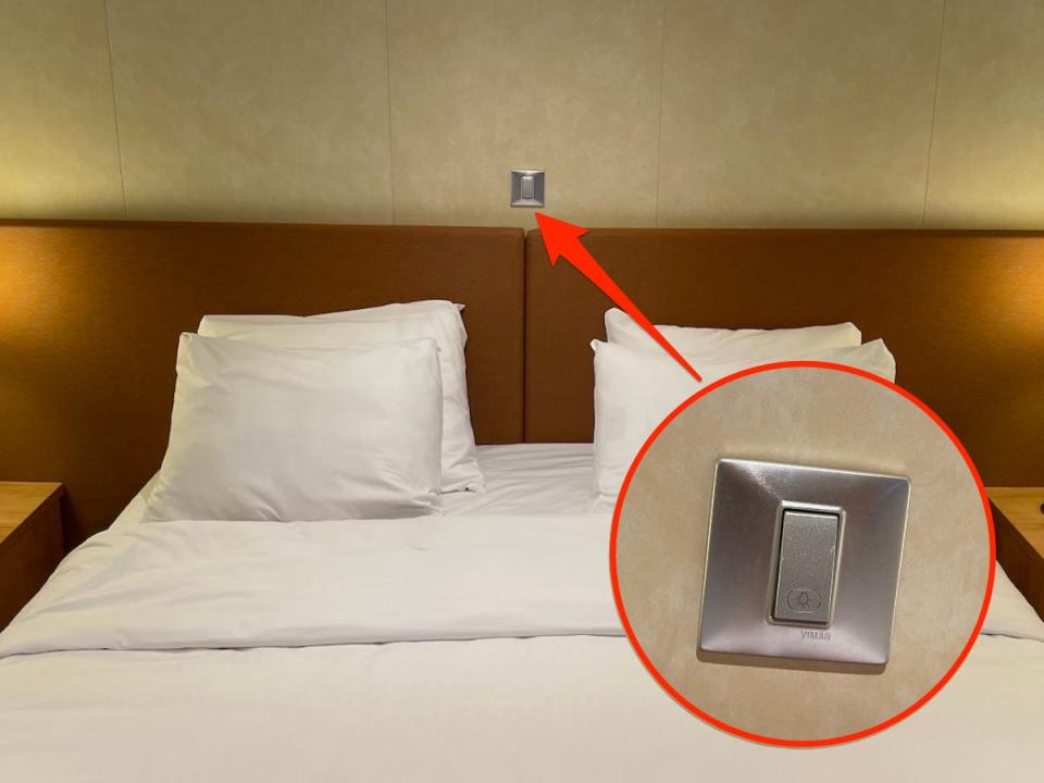An arrow points to a light switch above the middle of the bed's headboard.