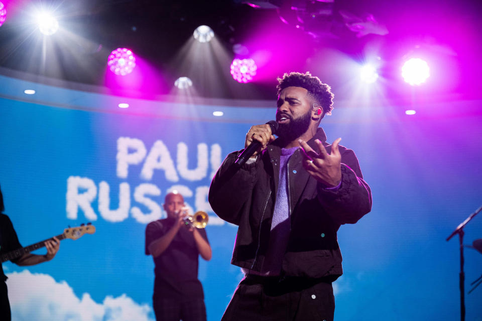 Paul Russell holds a mic on a TV studio set and sings. (Nathan Congleton  / TODAY)