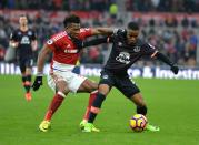 <p>Adama Traore is held off by Ademola Lookman</p>