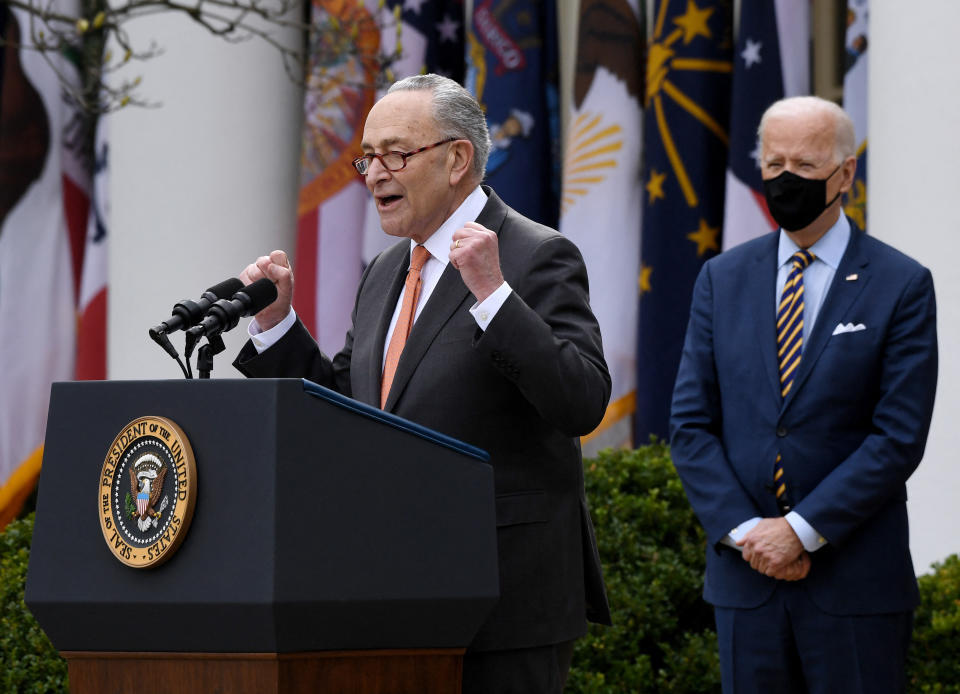 US President Joe Biden (R) listens as US Senate Majority Leader Senator Chuck Schumer (D-NY) during an event on the American Rescue Plan in the Rose Garden of the White House in Washington, DC, on March 12, 2021. (Photo by OLIVIER DOULIERY / AFP) (Photo by OLIVIER DOULIERY/AFP via Getty Images)