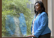 Yolanda Ogbolu, a nurse researcher at the University of Maryland, Baltimore, who advocated for two relatives during their COVID-19 hospital stays, looks out a window at the university's nursing school on Friday, June 11, 2021, in Baltimore. Government health officials say Native Americans, Latinos and Black people are two to three times more likely than whites to die of COVID-19. (AP Photo/Steve Ruark)