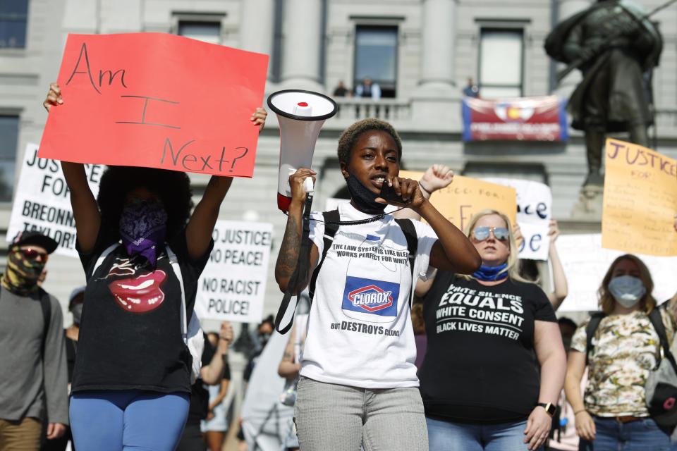 Keezy Allen leads a chant during a protest outside the State Capitol over the death of George Floyd, a handcuffed black man in police custody in Minneapolis, Thursday, May 28, 2020, in Denver. Close to 1,000 protesters walked from the Capitol down the 16th Street pedestrian mall during the protest. (AP Photo/David Zalubowski)
