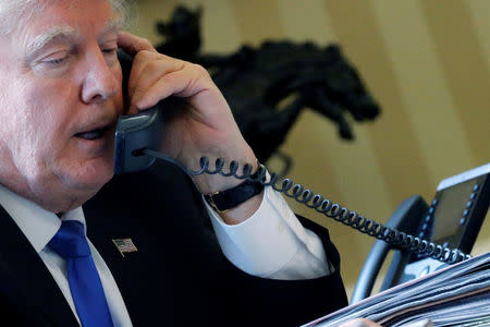 U.S. President Donald Trump speaks by phone with Russia's President Vladimir Putin in the Oval Office at the White House in Washington, U.S. January 28, 2017. REUTERS/Jonathan Ernst