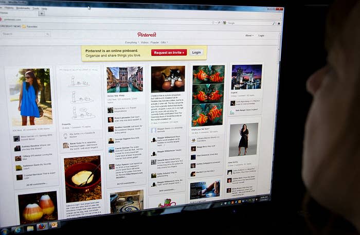 Someone looking at a Pinterest webpage on a computer screen, which displays various pins including fashion, food, and travel images