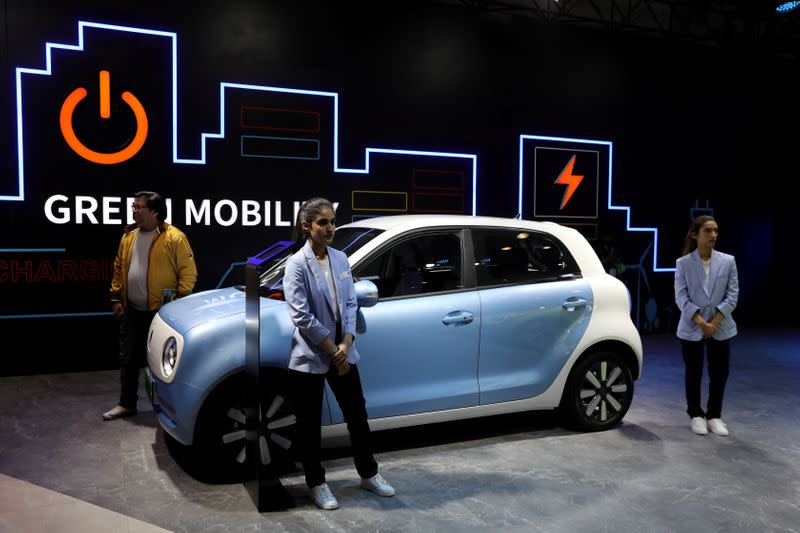 FILE PHOTO: Models pose next to Great Wall Motors (GWM) GWM R1 electric car at its pavilion at the India Auto Expo 2020 in Greater Noida