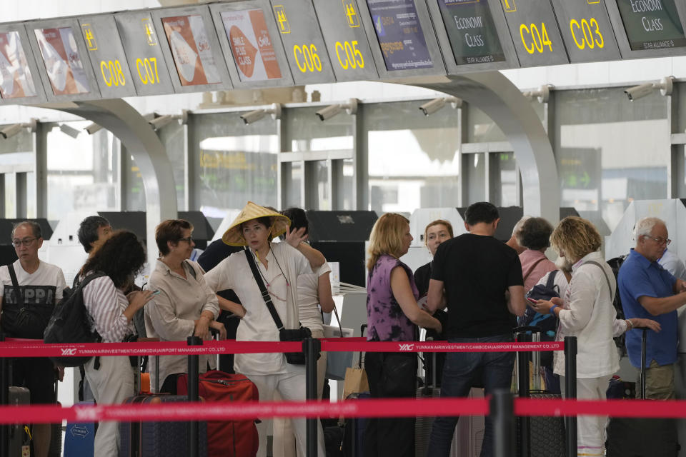 Tourists line up for check-in before departure at International Airport in Siem Reap province, Cambodia as it opened Thursday, Nov. 16, 2023. The new airport can handle 7 million passengers a year, with plans to augment it to handle 12 million passengers annually from 2040. It was constructed under a 55-year build-operate-transfer (BOT) program between Cambodia and China. (AP Photo/Heng Sinith)