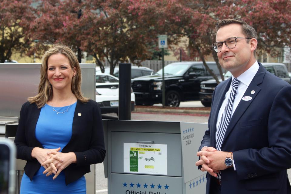 Michigan Secretary of State Jocelyn Benson and Ottawa County Clerk Justin Roebuck pose for a photo near Holland City Hall on Election Day, Tuesday, May 4, 2021, in Holland, Mich.