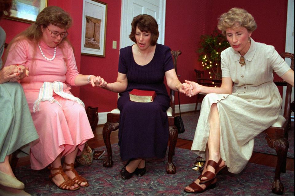 A group joins hands in prayer during a June 1996 meeting of the Weigh Down Workshop in Nashville, Tenn. After going through three sessions of Weigh Down Workshop, Donna Peak, center, said she had reduced her weight from 276 pounds to 153.