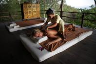 A woman gets a Thai massage in the open air massage sala at the Kamalaya Wellness Sanctuary.