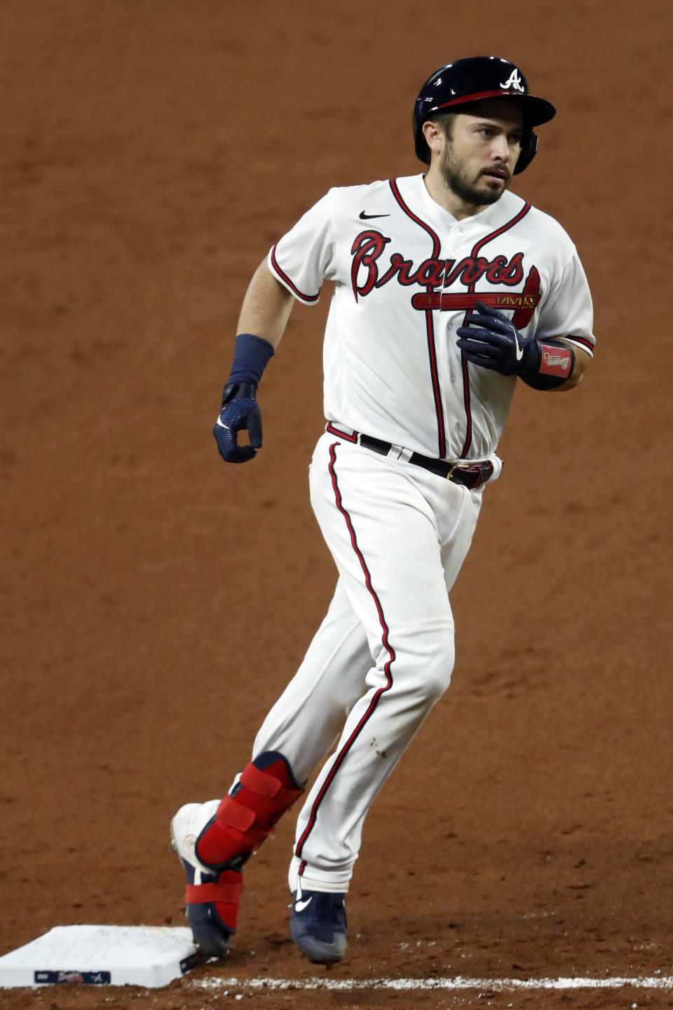 Atlanta Braves' Travis d'Arnaud rounds third base after hitting a home run in the fifth inning of a baseball game against the New York Mets Monday, Aug. 3, 2020, in Atlanta. (AP Photo/John Bazemore)