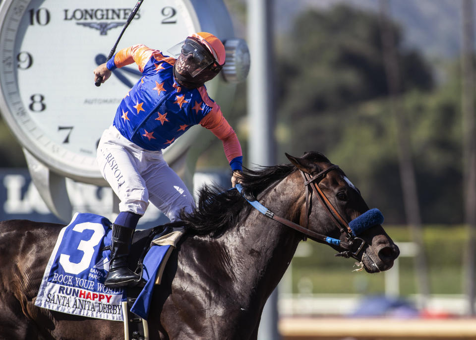 In a photo provided by Benoit Photo, Rock Your World and jockey Umberto Rispoli win the Grade I $750,000 Santa Anita Derby Saturday, April 3, 2021 at Santa Anita Park in Arcadia, Calif. (Benoit Photo via AP)