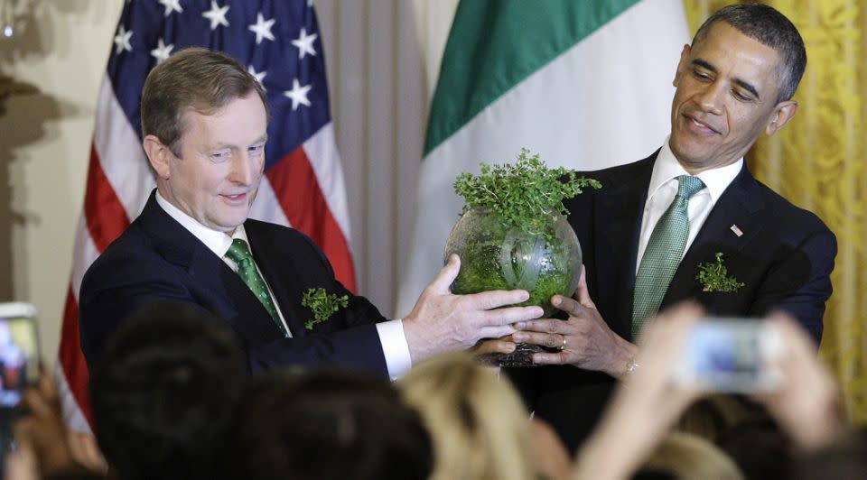 Irish Prime Minister Enda Kenny (L) bestows a gift of an etched bowl filled with traditional shamrocks to President Barack Obama during a St. Patrick's Day reception at the White House on March 19, 2013. Photo: Reuters/Jonathan Ernst