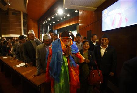 Newly elected Nepalese Prime Minister Sushil Koirala greets media personnel as he walks out from the Parliament after being elected as the Prime Minister in Kathmandu February 10, 2014. REUTERS/Navesh Chitrakar