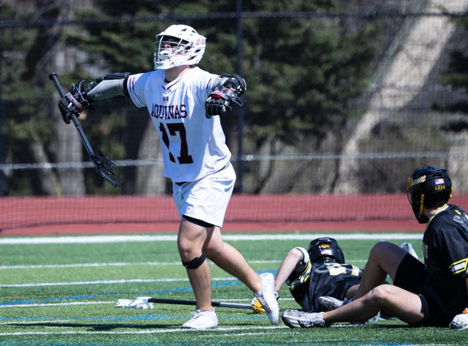 Aquinas' Tano Auriuso celebrates a goal against McQuaid.