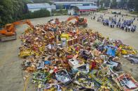 <p>More than 2,860 gambling machines seized by police officers are destroyed in China (Rex features) </p>