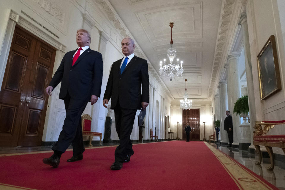 President Donald Trump walks with Israeli Prime Minister Benjamin Netanyahu to an event in the East Room of the White House in Washington, Tuesday, Jan. 28, 2020, to announce the Trump administration's much-anticipated plan to resolve the Israeli-Palestinian conflict. (AP Photo/Alex Brandon)