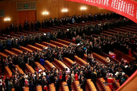 Delegates leave the hall after the closing ceremony of the 19th National Congress - Credit: EPA/HOW HWEE YOUNG