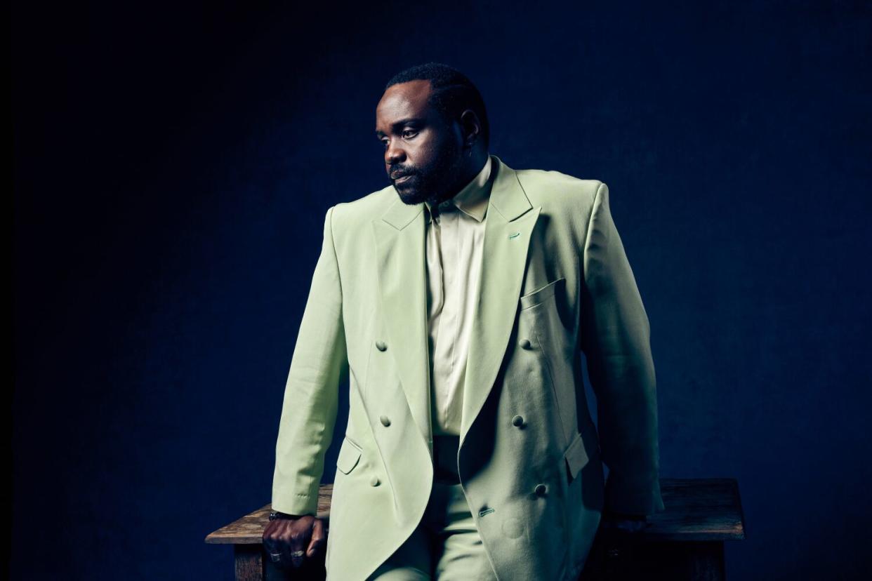 Brian Tyree Henry wears a pale green suit for a portrait.