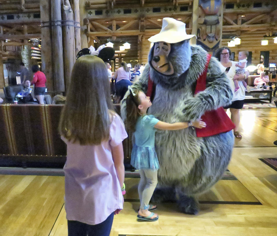 Disney character "Big Al," from Country Bear Jamboree, joins guests sheltering in place at their hotel at Disney's Wilderness Lodge in Lake Buena Vista, Fla., Wednesday, Sept. 28, 2022, as the first effects of Hurricane Ian are felt in Central Florida. Disney, along with Universal and SeaWorld, closed their Central Florida theme parks in response to the storm. (Joe Burbank/Orlando Sentinel via AP)