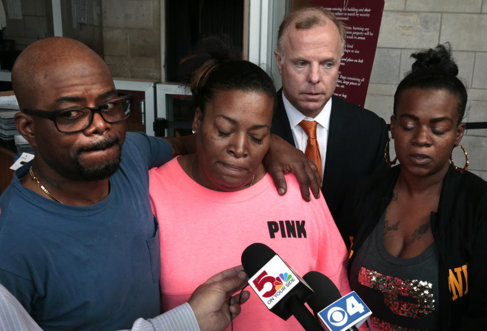 Karen Carter, center, the mother of Ashley Hall, a shoplifting suspect shot by a Ladue police officer last month, is interviewed alongside Hall's father, Robert Hall, Sr., Aigner Hall, right, Hall's sister, and family attorney William K. Holland at the St. Louis County Justice Center on Wednesday, May 1, 2019 in Clayton, Mo. Julia Crews, a 13-year police officer, was charged Wednesday with second-degree assault by St. Louis County Prosecutor Wesley Bell. (Robert Cohen/St. Louis Post-Dispatch via AP)