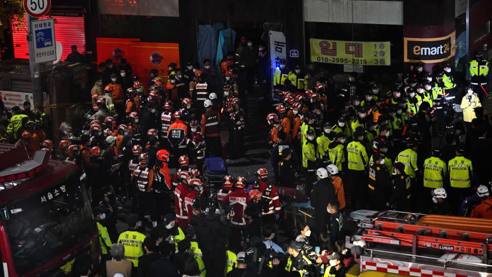 Rescue officials and police gather in the district of Itaewon in Seoul on October 30, 2022. - Anthony Wallace/AFP/Getty Images