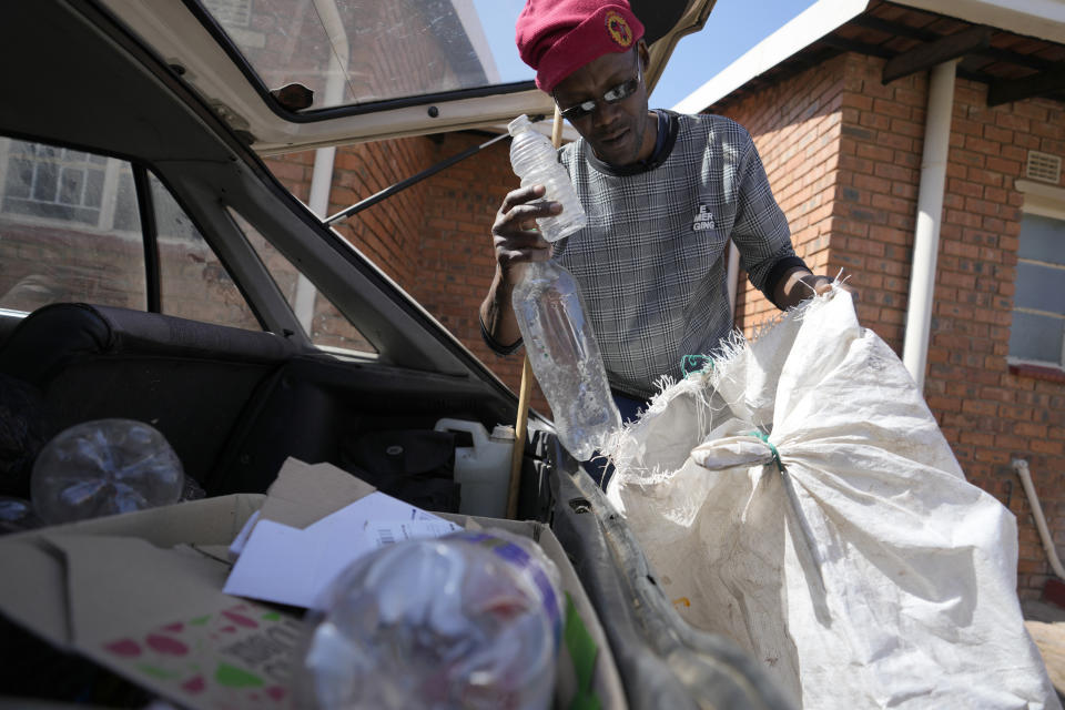 Themba Khumalo collects empty metal and plastic containers to sell in bulk for recycling and support his family in Daveyton township, east of Johannesburg, South Africa, Tuesday, Aug. 1, 2023. South Africa's official unemployment rate of 33% is the highest in the world, and economists say it's even higher at 42% if you count those who have given up looking for work and have dropped off unemployment systems. (AP Photo/Themba Hadebe)