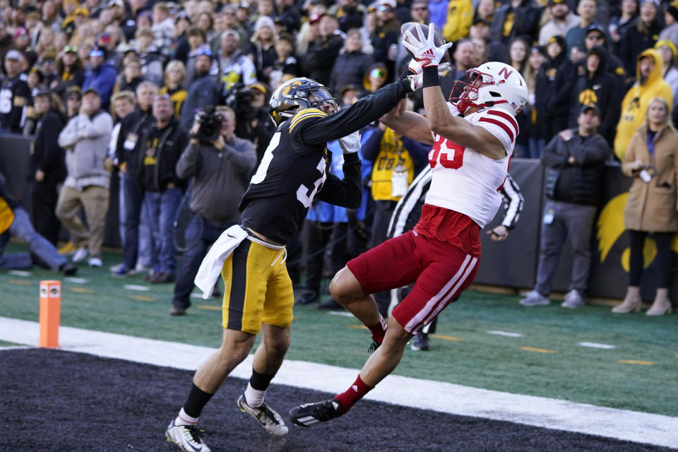 Iowa defensive back Riley Moss, left, breaks up a pass intended for Nebraska wide receiver Oliver Martin (89) during the first half of an NCAA college football game, Friday, Nov. 25, 2022, in Iowa City, Iowa. (AP Photo/Charlie Neibergall)