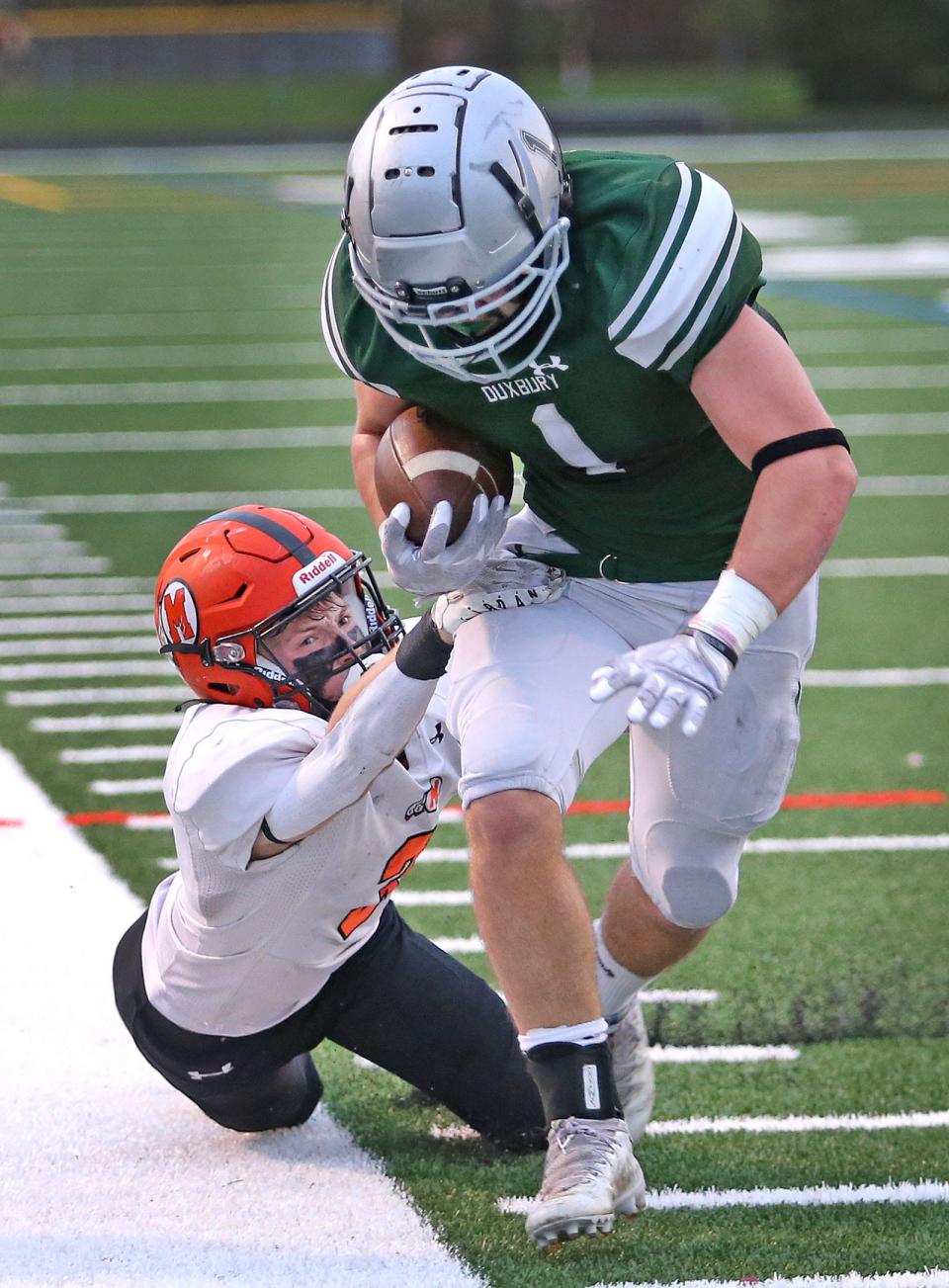 Dragon Alex Barlow tries to keep in bounds as Sachem Nate Tullish tries to drag him out.
The Duxbury Dragons hosted the Middleboro Sachems in MIAA football tournament action on Friday November 11, 2022.