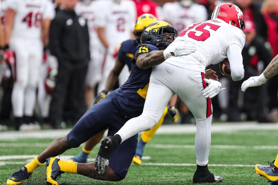 Michigan linebacker Ernest Hausmann tackles Indiana defensive back Nic Toomer during the first half of U-M's 52-7 win over Indiana on Saturday, Oct. 14, 2023, in Ann Arbor.