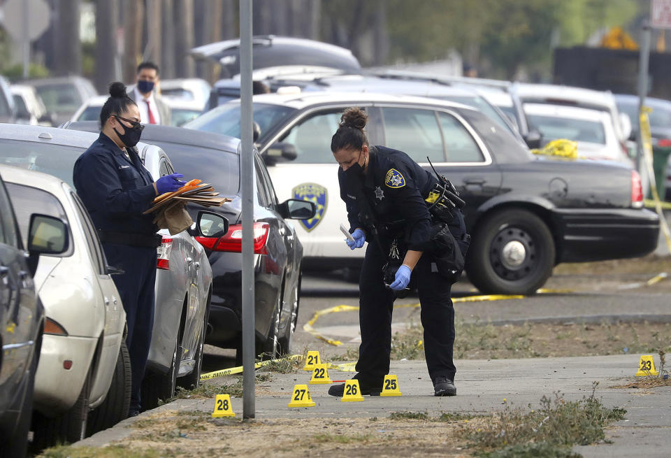 Image: Oakland police officers investigate a shooting with a police officer at a marijuana business (Aric Crabb / Bay Area News via AP file)