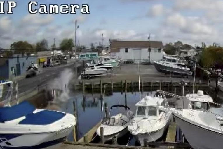 The car crashed into the water before members of the public jumped in to rescue the driver and passenger (AP)