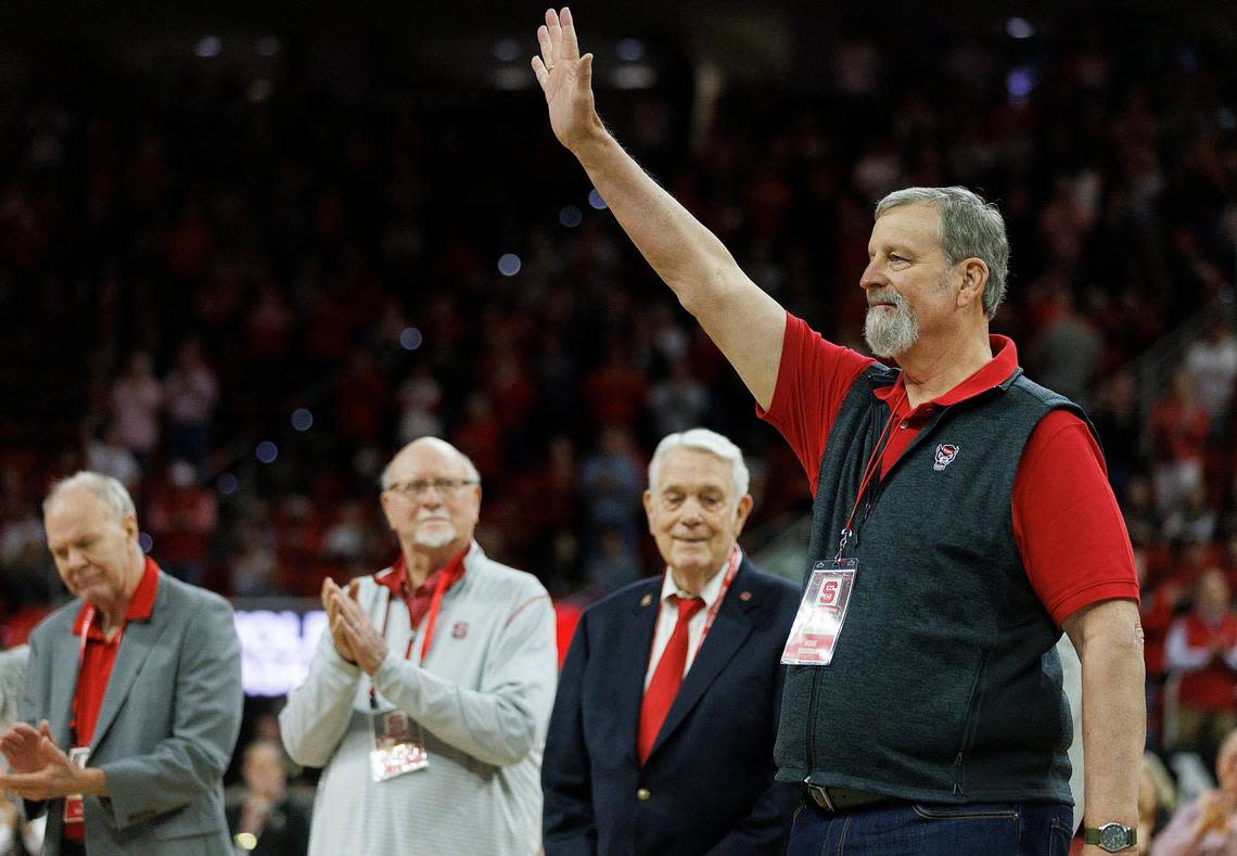 Mike Buurma acknowledges the crowd as members of the N.C. State men’s basketball 1974 national championship team are honored during a halftime ceremony on Saturday, Feb. 24, 2024, at PNC Arena in Raleigh, N.C.