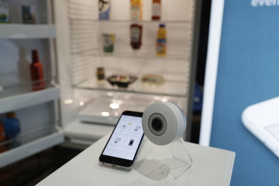 The FridgeCam is on display at the Smarter booth during CES Unveiled, Tuesday, Jan. 3, 2017, in Las Vegas. The camera takes a picture every time you use the refrigerator and has recognition software that can alert you when something is about to expire. (AP Photo/John Locher)