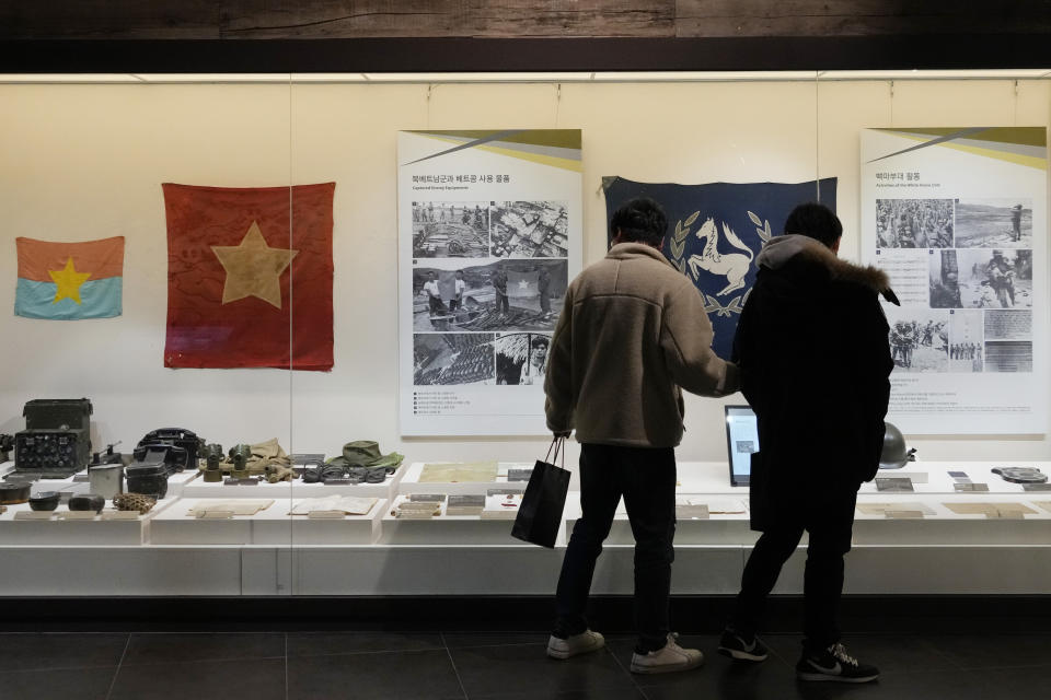 Visitors watch records of South Korean military soldiers during the Vietnam War at the War Memorial of Korea in Seoul, South Korea, Friday, Feb. 17, 2023. South Korea's top military official on Friday insisted the country's soldiers didn't commit any massacres during the Vietnam War and indicated the government will appeal a ruling that ordered compensation for a Vietnamese woman who lost several relatives to a shooting rampage blamed on South Korean marines in 1968. (AP Photo/Ahn Young-joon)