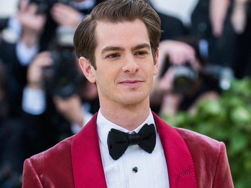 Andrew Garfield wearing a red velvet suit and black bow-tie at the 2018 Met Gala.