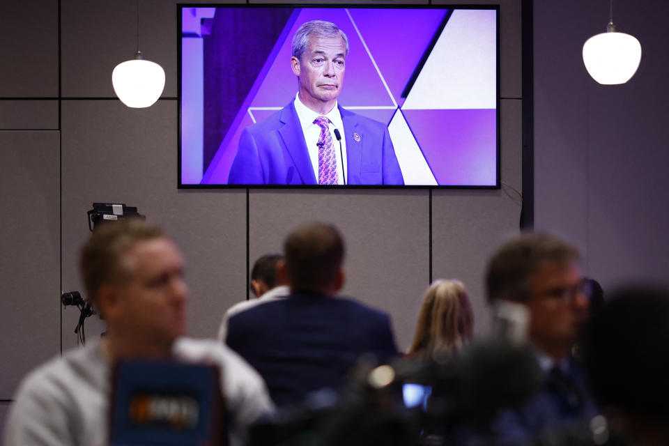 Journalists listen to Leader of Reform UK Nigel Farage inside the BBC Media Room. Image: BENJAMIN CREMEL / AFP via Getty.